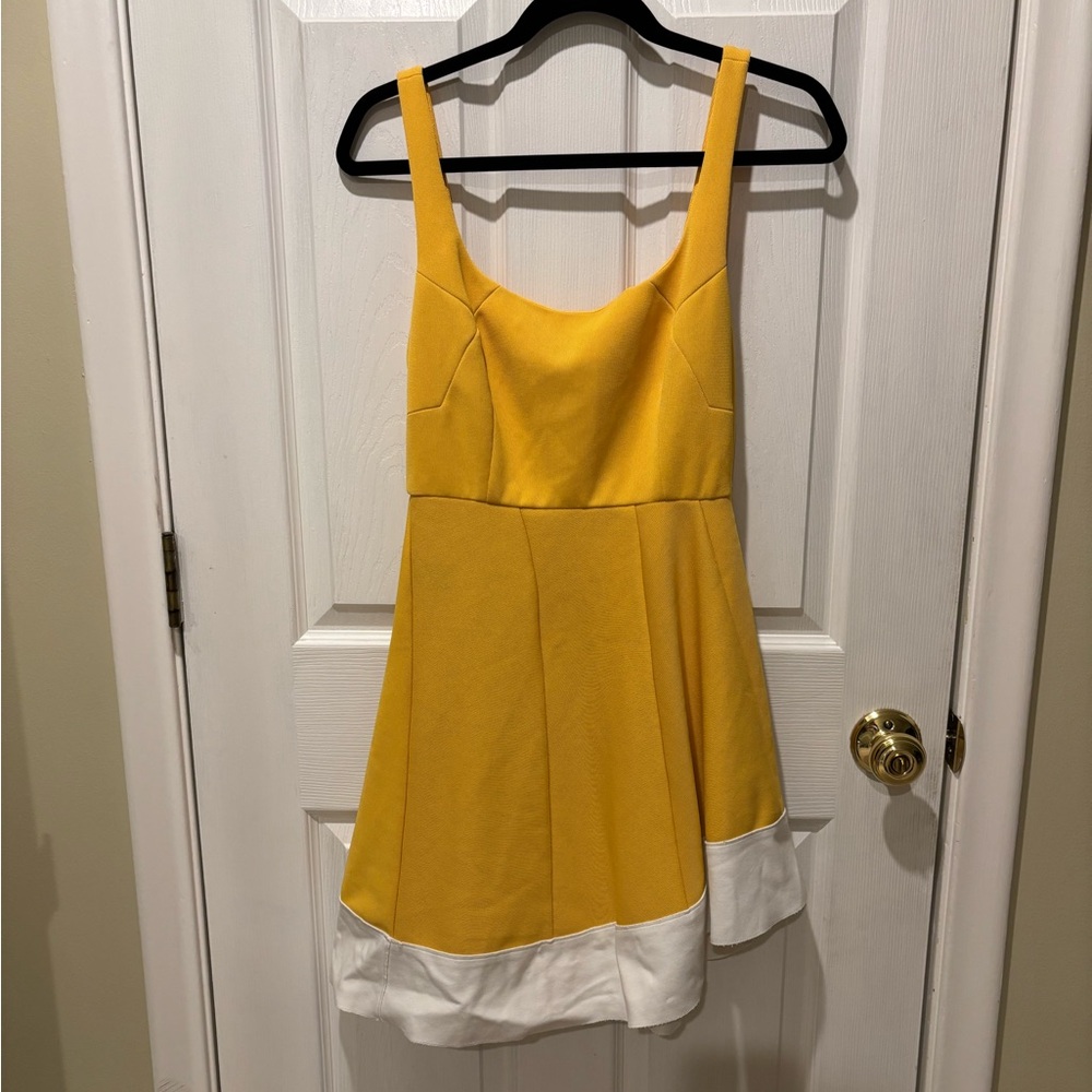 Esteban Cortazar yellow and white dress